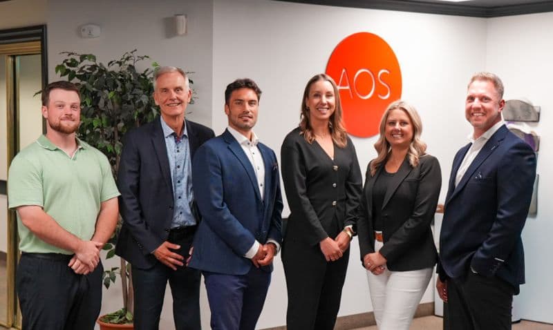 AOS representatives and Xerox Canada visitors in an AOS-branded reception area